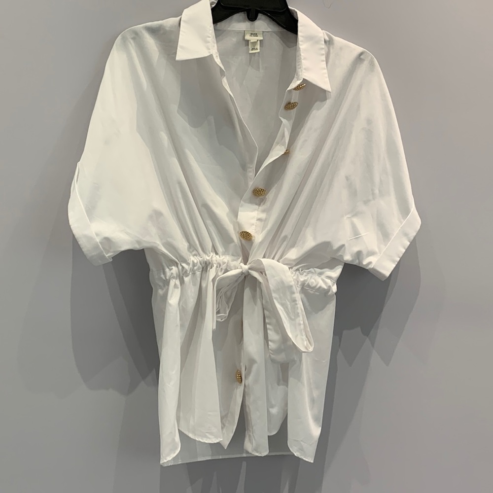 White button down with gold detail buttons and tie belt